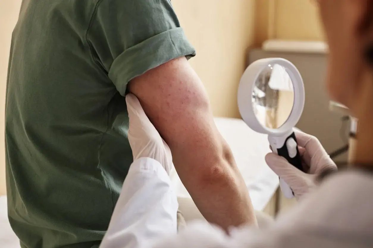 Dermatologist examining patient